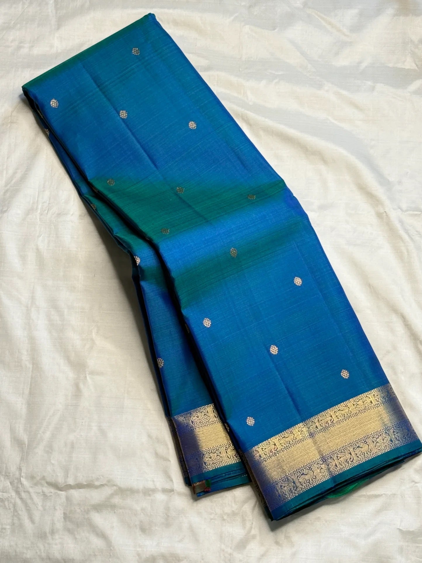 Peacock blue pure silk KanchiPattu Butta saree, front drape view