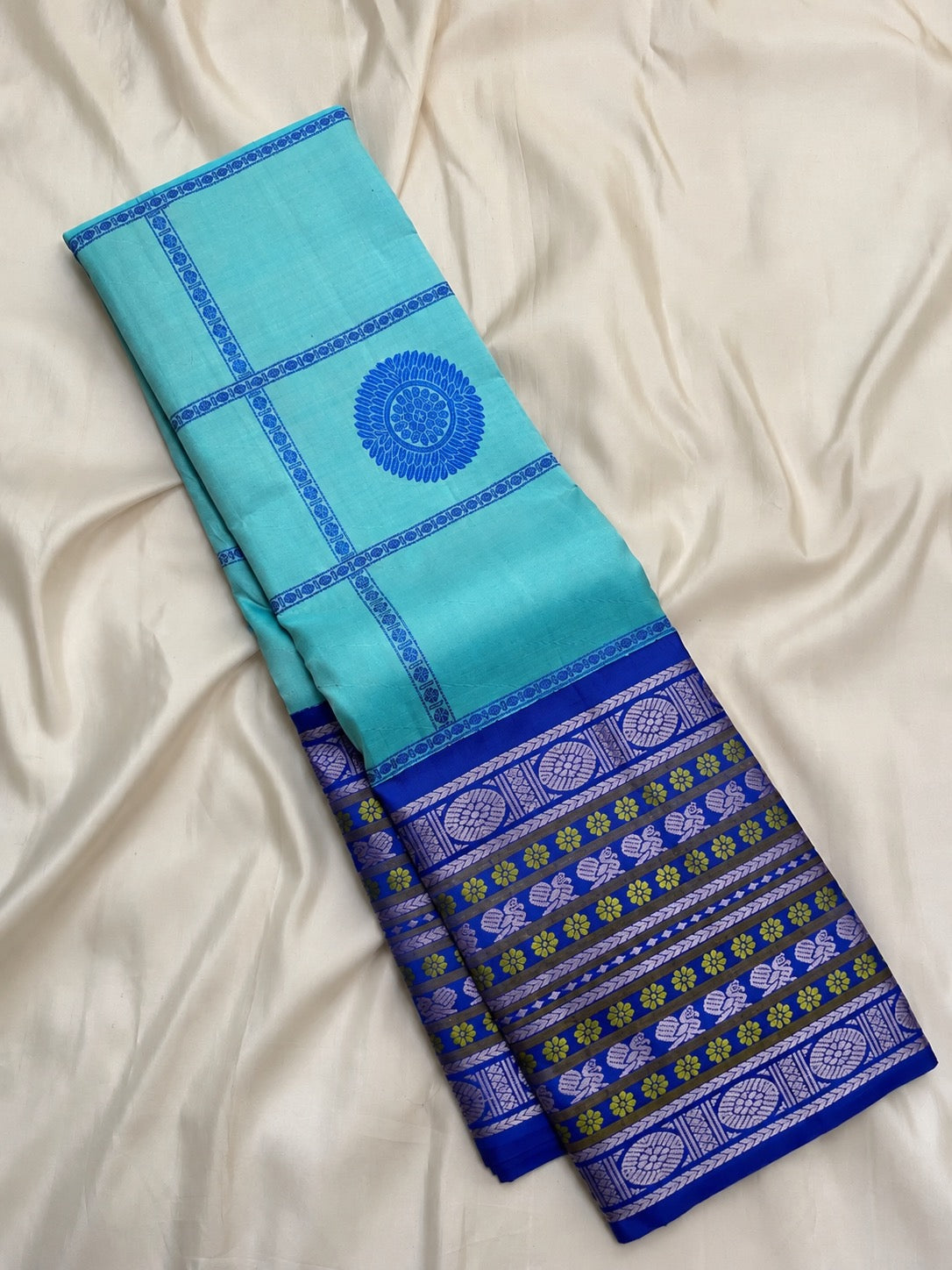 Folded aqua blue handwoven Pure Silk Kanchipuram Pattupet saree.
