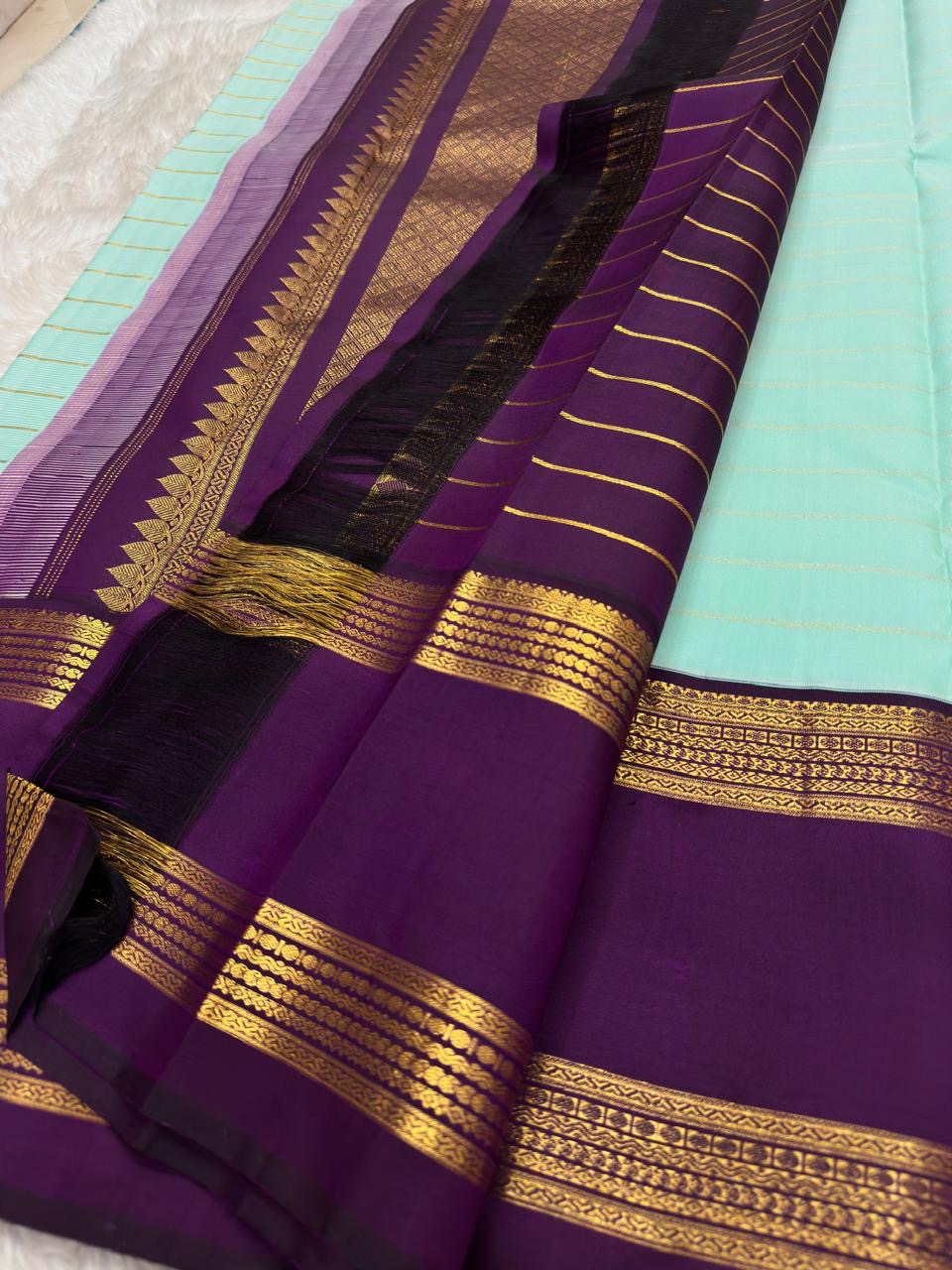 Fresh Aqua Blue pure silk KanchiPattu saree, Rettapet weave with Deep Aubergine border — folded view