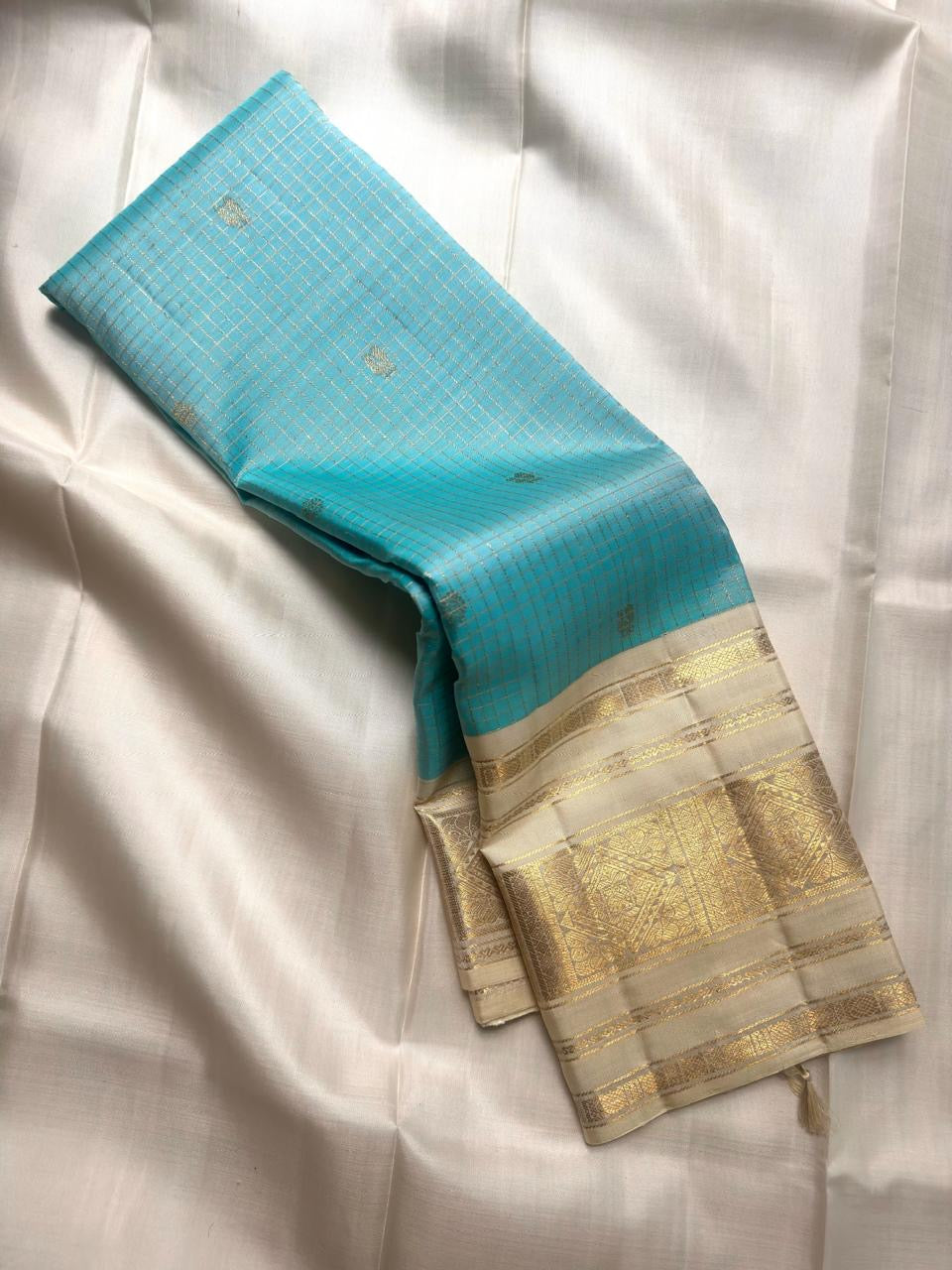Aqua Blue and Warm Ivory Pure Silk Kanchipuram Zari Kattam saree with intricate metallic zari panels.