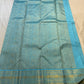 Close-up of gold zari checks on an aqua blue Kanchipuram Zari Kattam saree body