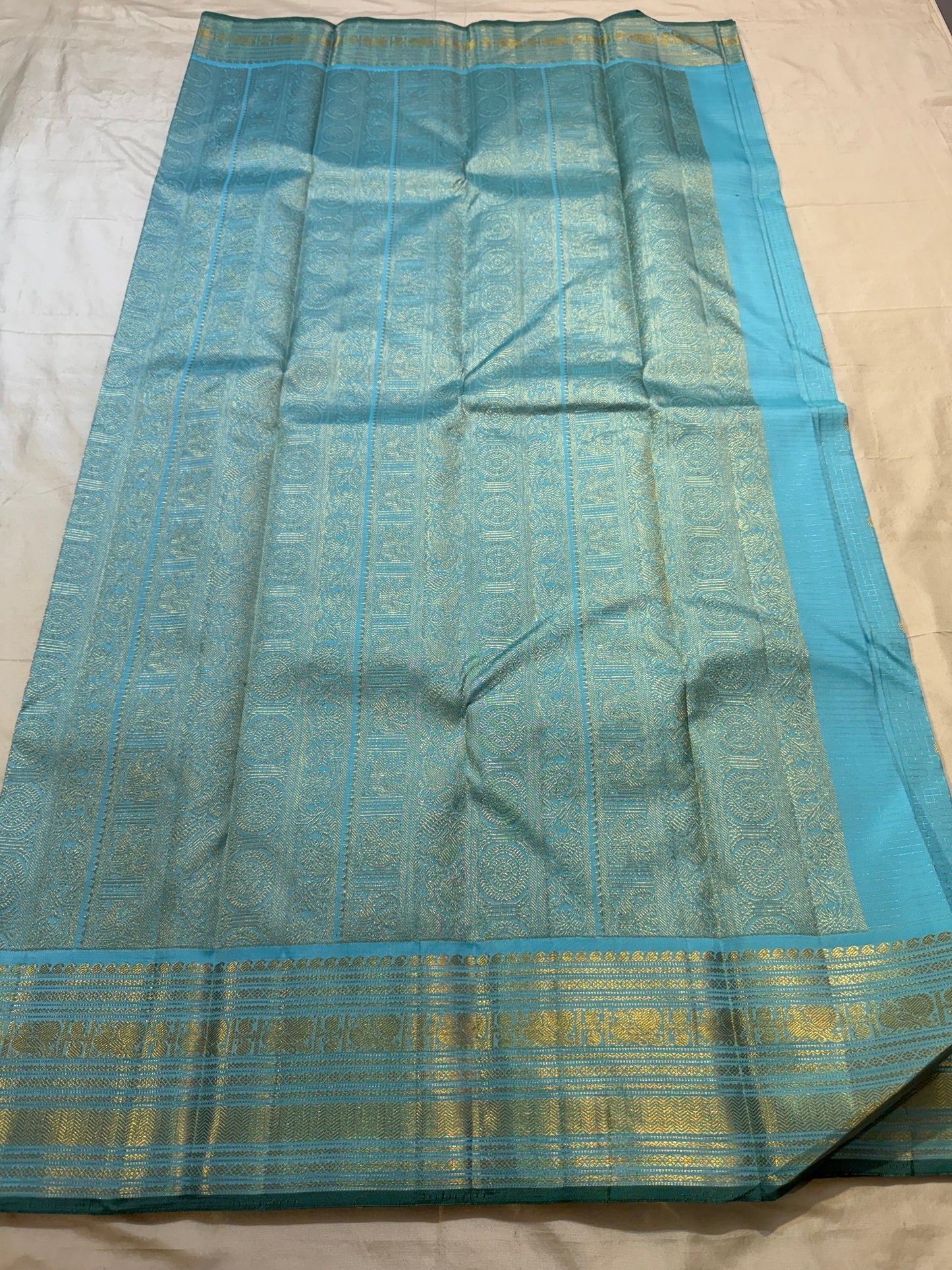 Close-up of gold zari checks on an aqua blue Kanchipuram Zari Kattam saree body