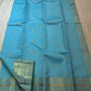 Close-up of gold zari buttas on an aqua blue Kanchipuram Zari Kattam saree