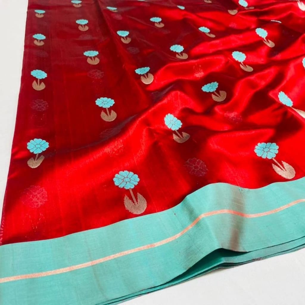 Close-up of Aqua Blue floral buttas with soft-gold stems on the Vermilion Red Pattu Silk Chanderi saree