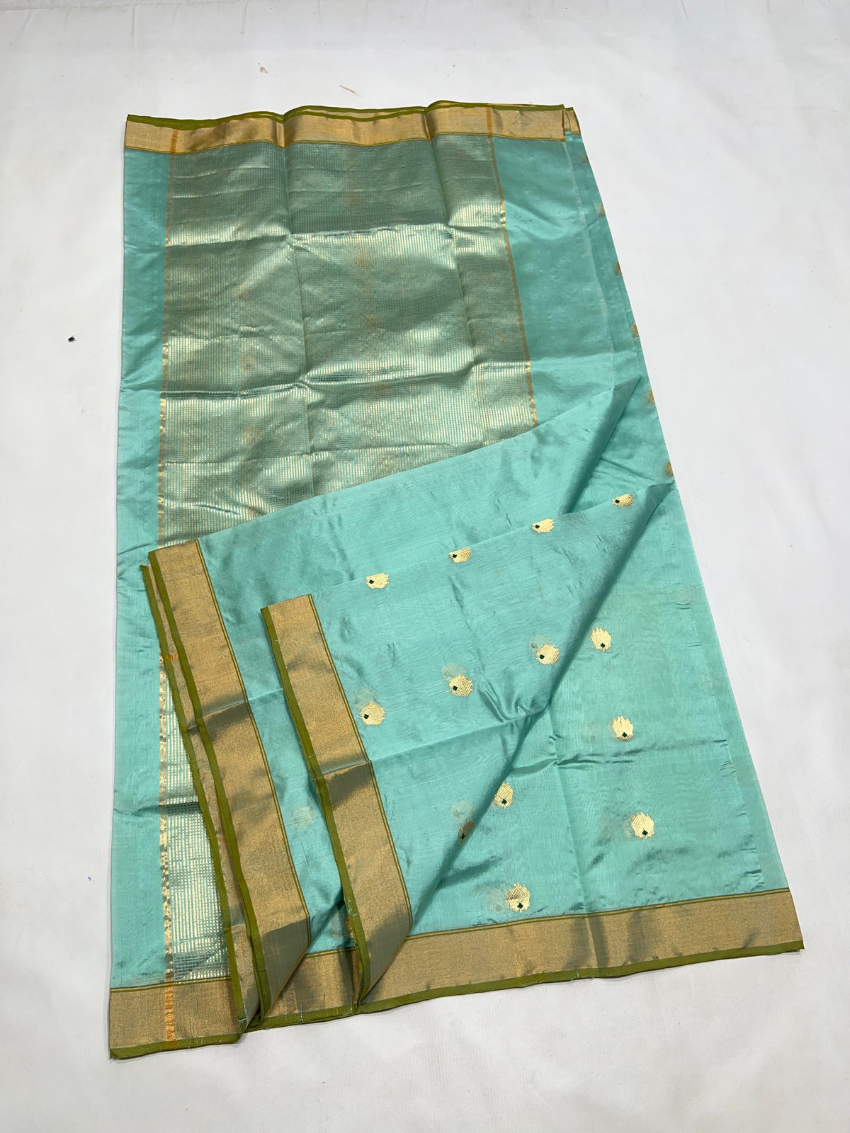 Close-up of the gold-toned border with slender Olive Green edging on an Aqua Blue Katan Silk Chanderi saree