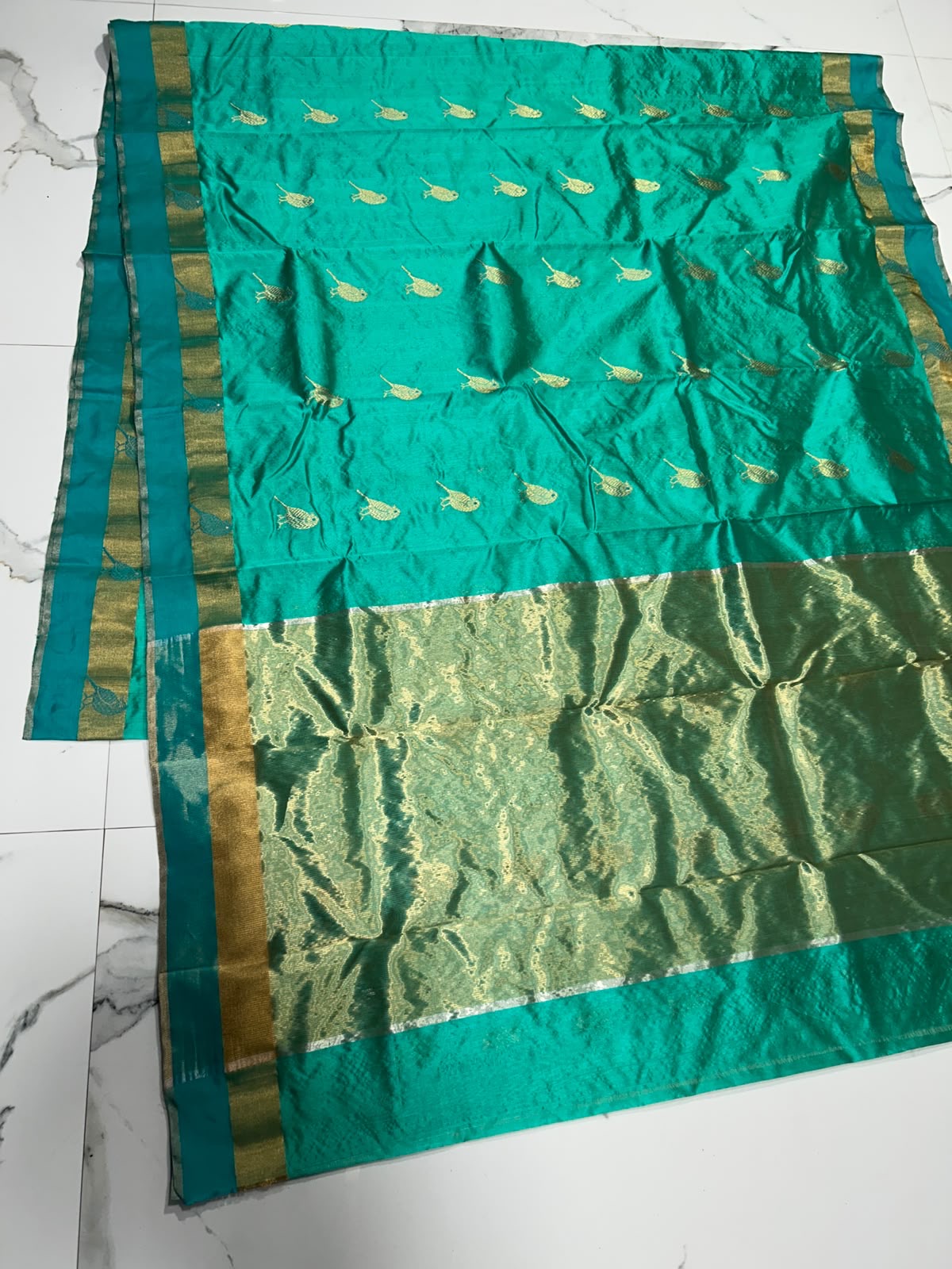 Handloom Turquoise Green Chanderi saree showing antique-gold pallu and gold bird motifs along the body and border