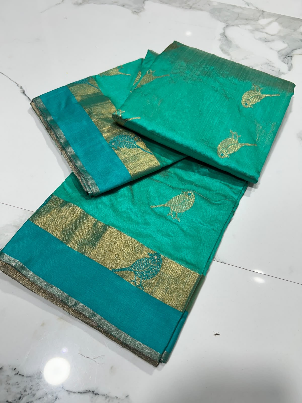 Turquoise Green Chanderi saree pallu detail, broad antique-gold woven field with turquoise and gold bands