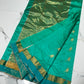 Turquoise and teal Chanderi silk saree with gold bird motifs, narrow woven border and broad metallic pallu