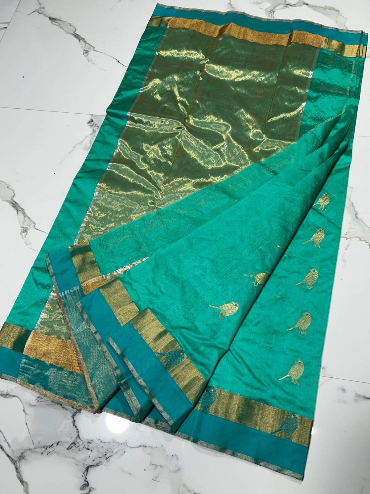 Turquoise and teal Chanderi silk saree with gold bird motifs, narrow woven border and broad metallic pallu