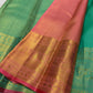 Close-up of gold zari buttas on aqua pure silk Kanchi Pattu saree