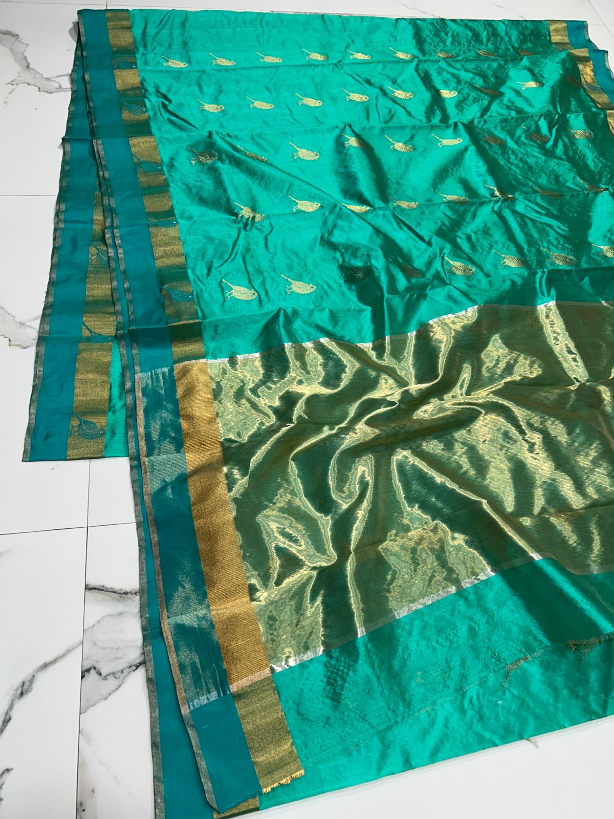 Full view of Turquoise Green Pattu Silk Chanderi with rows of woven bird motifs and luminous antique-gold pallu