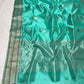 Aqua Turquoise Pattu Silk Chanderi saree with broad silver-toned border and fine deep green lines