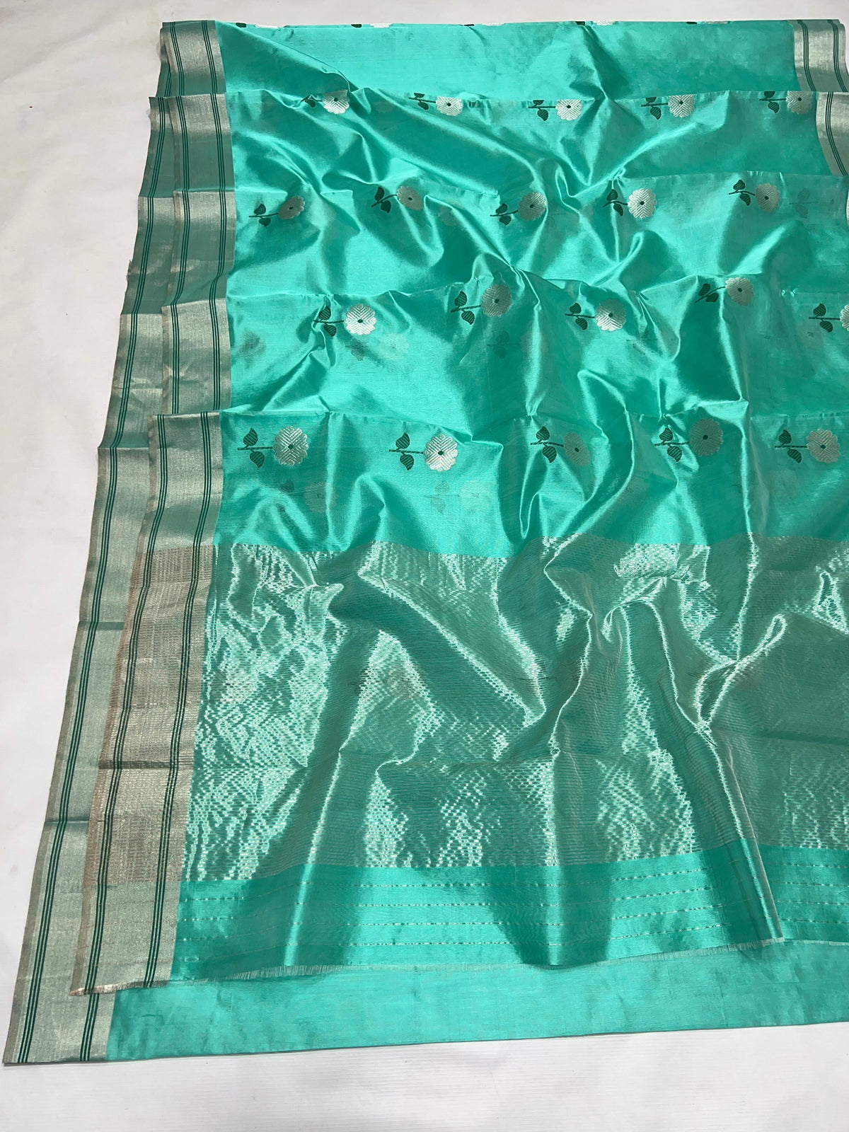 Aqua Turquoise Pattu Silk Chanderi saree with broad silver-toned border and fine deep green lines