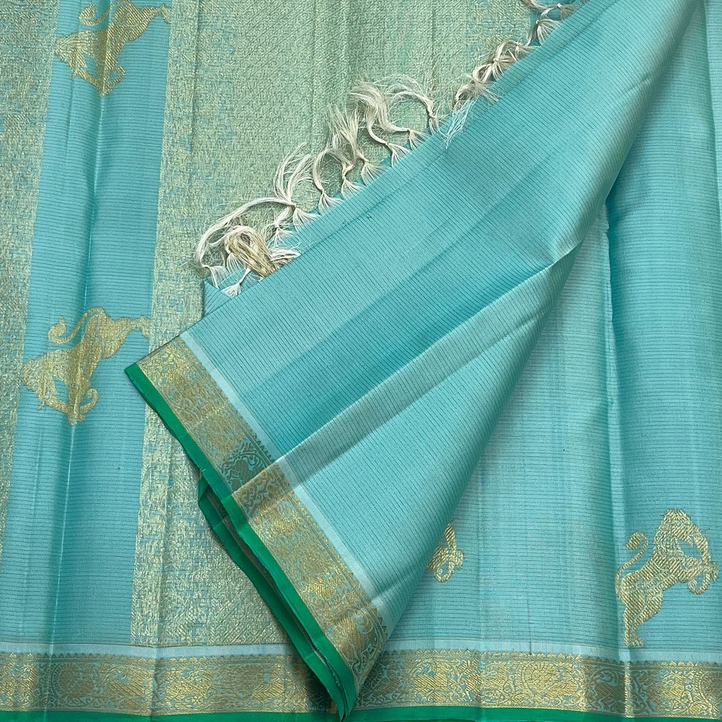 Aqua Ice Blue handwoven silk saree with traditional gold zari figural motifs.