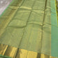 Circular zari medallion buttas on Aqua Mint Kancheepuram silk.
