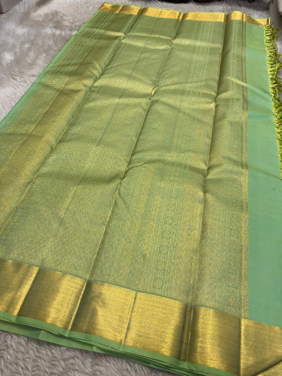 Circular zari medallion buttas on Aqua Mint Kancheepuram silk.