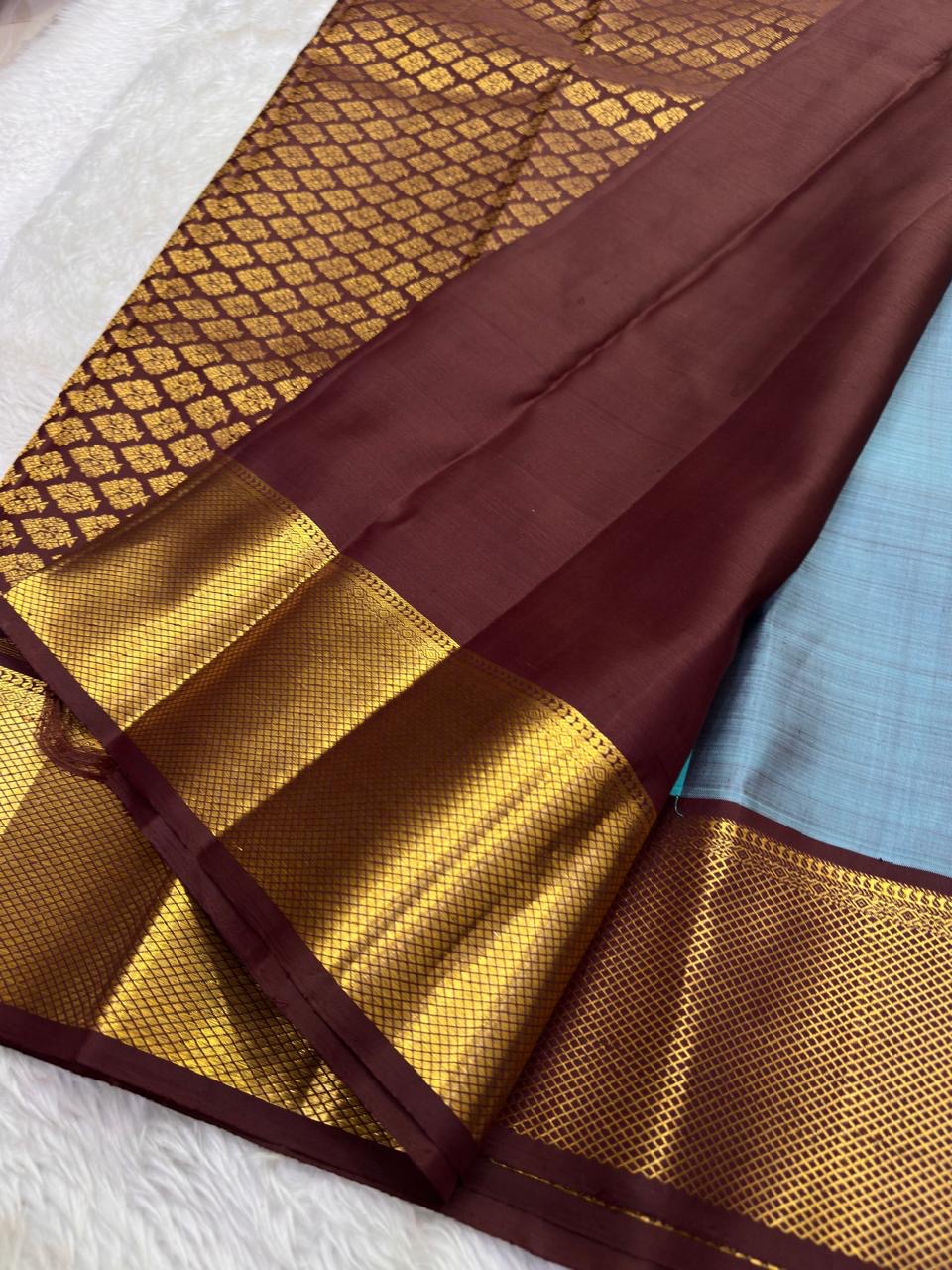 Gold-zari buttas spaced across Aqua Blue Kanchipuram silk.
