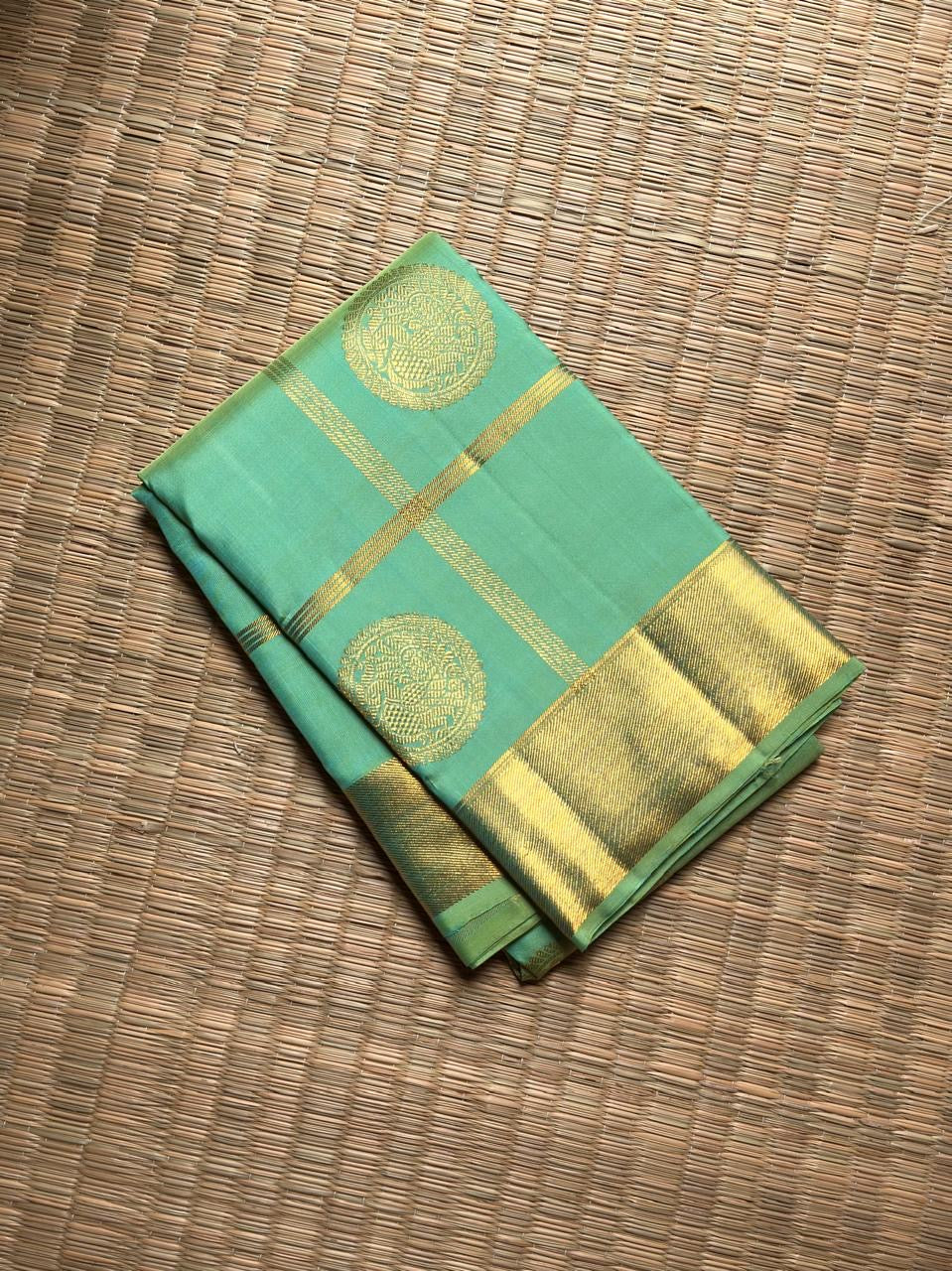 Aqua Mint Kanjivaram silk saree with Pale Gold zari border.