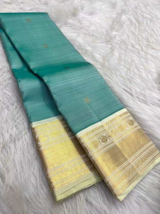 Warm Ivory gold zari traditional motif border on Aqua Teal Kanchipuram saree