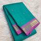 Bright aqua turquoise silk body showing individually spaced small classic-gold zari buttas.