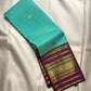 Aqua Turquoise pure silk saree with traditional gold zari peacock buttas and contrast border.
