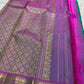 Handwoven Kanjeevaram Butta saree with an open turquoise body and small individually spaced gold motifs.