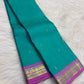 Aqua turquoise Pure Silk Kanjeevaram saree with small gold zari buttas and a vivid Orchid Pink zari border.