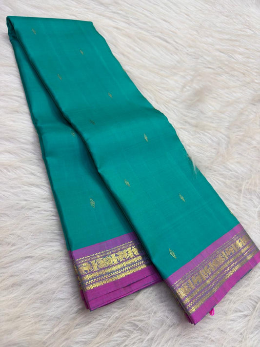 Aqua turquoise Pure Silk Kanjeevaram saree with small gold zari buttas and a vivid Orchid Pink zari border.