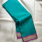 Aqua Turquoise handwoven pure silk Kanjivaram Butta saree with Rani Pink contrast border.