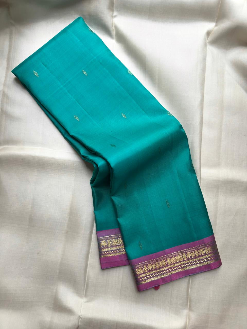 Aqua Turquoise handwoven pure silk Kanjivaram Butta saree with Rani Pink contrast border.