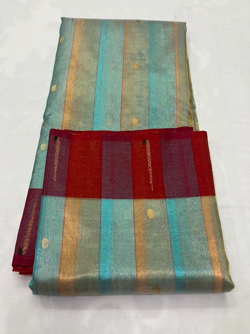 Deep-red border on aquamarine and gold Chanderi saree