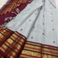 Close view of Kalam paisley buttas on the grey silk body of a Kanchipuram saree