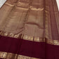 Deep Arakku Garnet pure silk Kanchipuram Rettapet saree with dense miniature poo buttas and antique-gold zari.