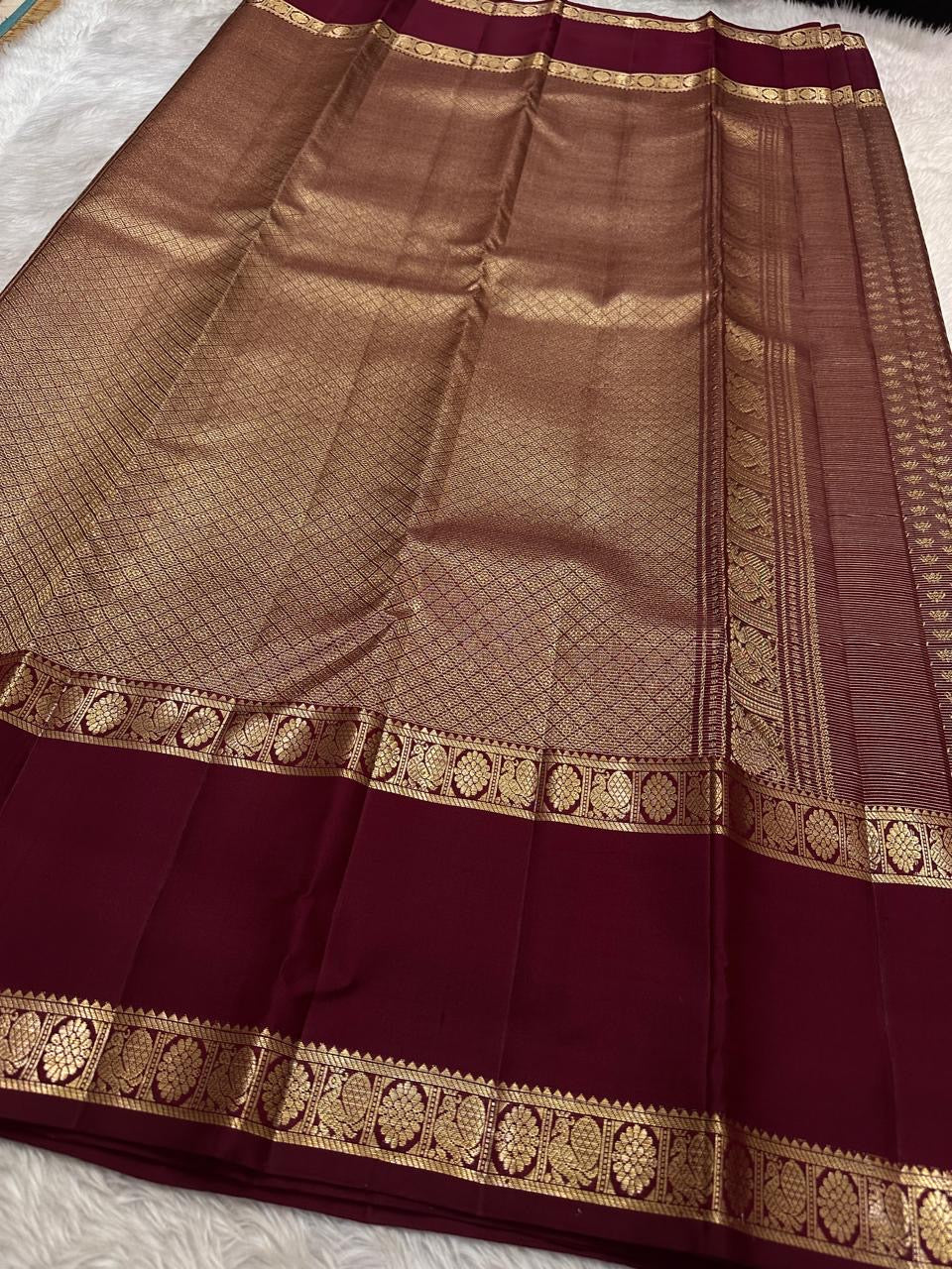 Deep Arakku Garnet pure silk Kanchipuram Rettapet saree with dense miniature poo buttas and antique-gold zari.
