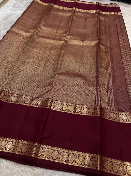Deep Arakku Garnet pure silk Kanchipuram Rettapet saree with dense miniature poo buttas and antique-gold zari.