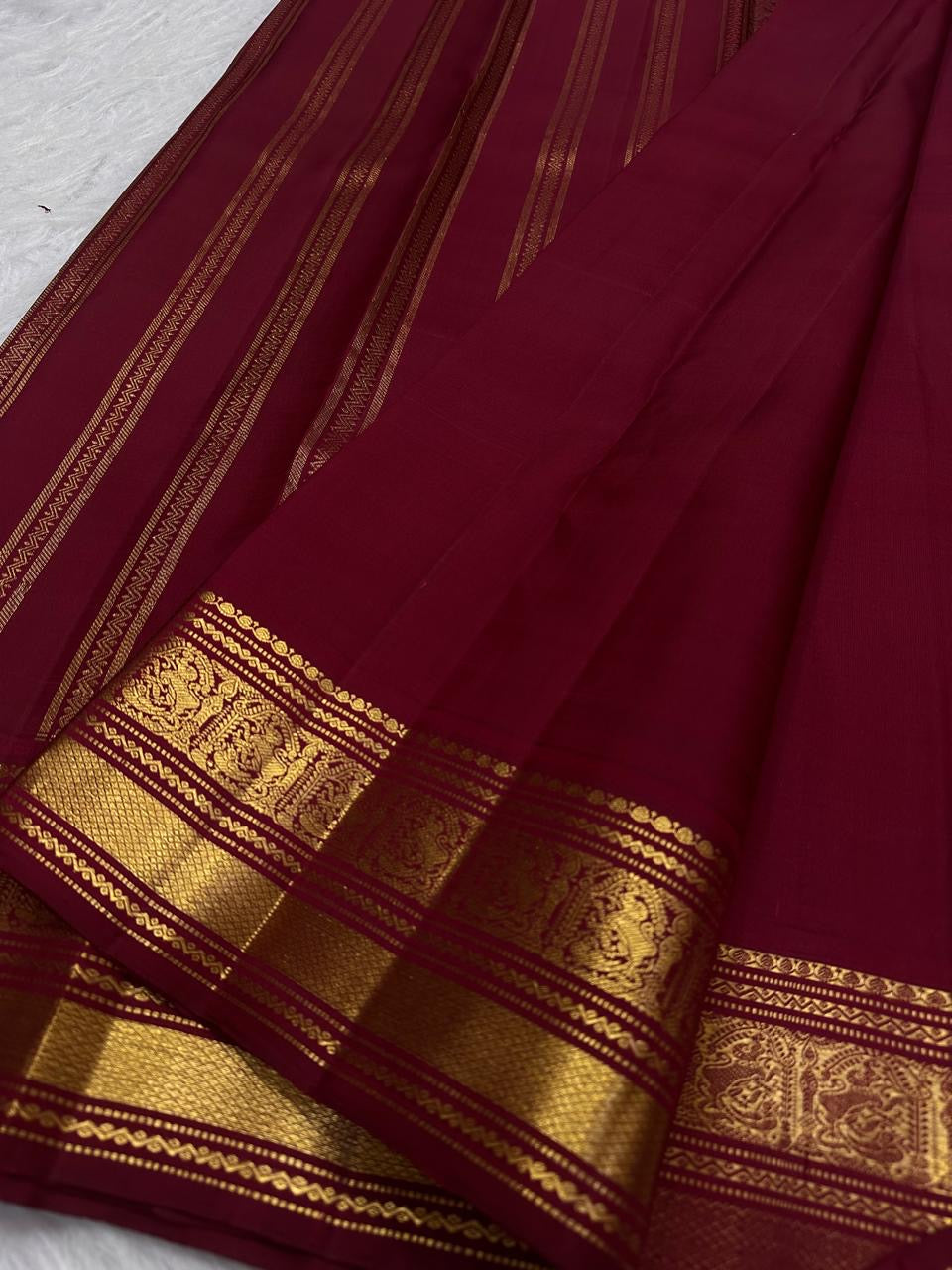 Arakku Kanjeevaram saree with broad gold Pettu, geometric Kattam and floral medallion bands