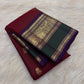 Deep Arakku Maroon Kanchipuram body with petite traditional gold zari buttas.