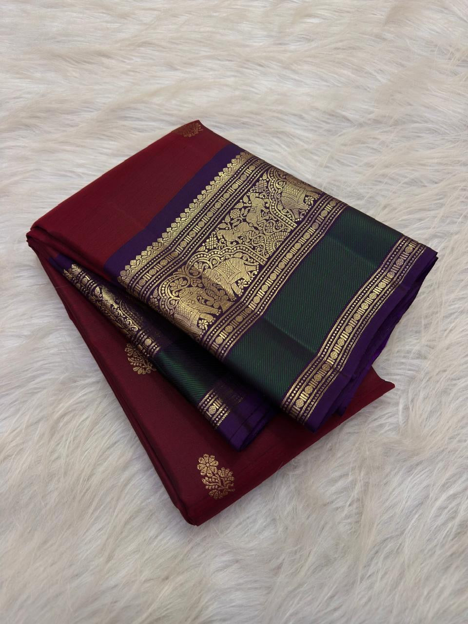 Deep Arakku Maroon Kanchipuram body with petite traditional gold zari buttas.