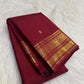 Handwoven Burgundy Kanchipuram saree with ornate Poo-Kodi Jaal and luminous gold border