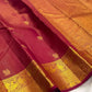 Arakku maroon Pure Silk Kanchipuram saree draped, showing the gold zari buttas