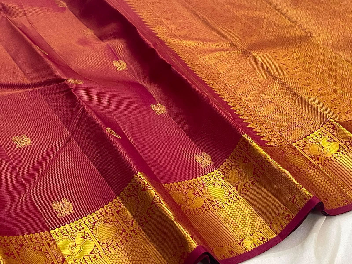 Arakku maroon Pure Silk Kanchipuram saree draped, showing the gold zari buttas