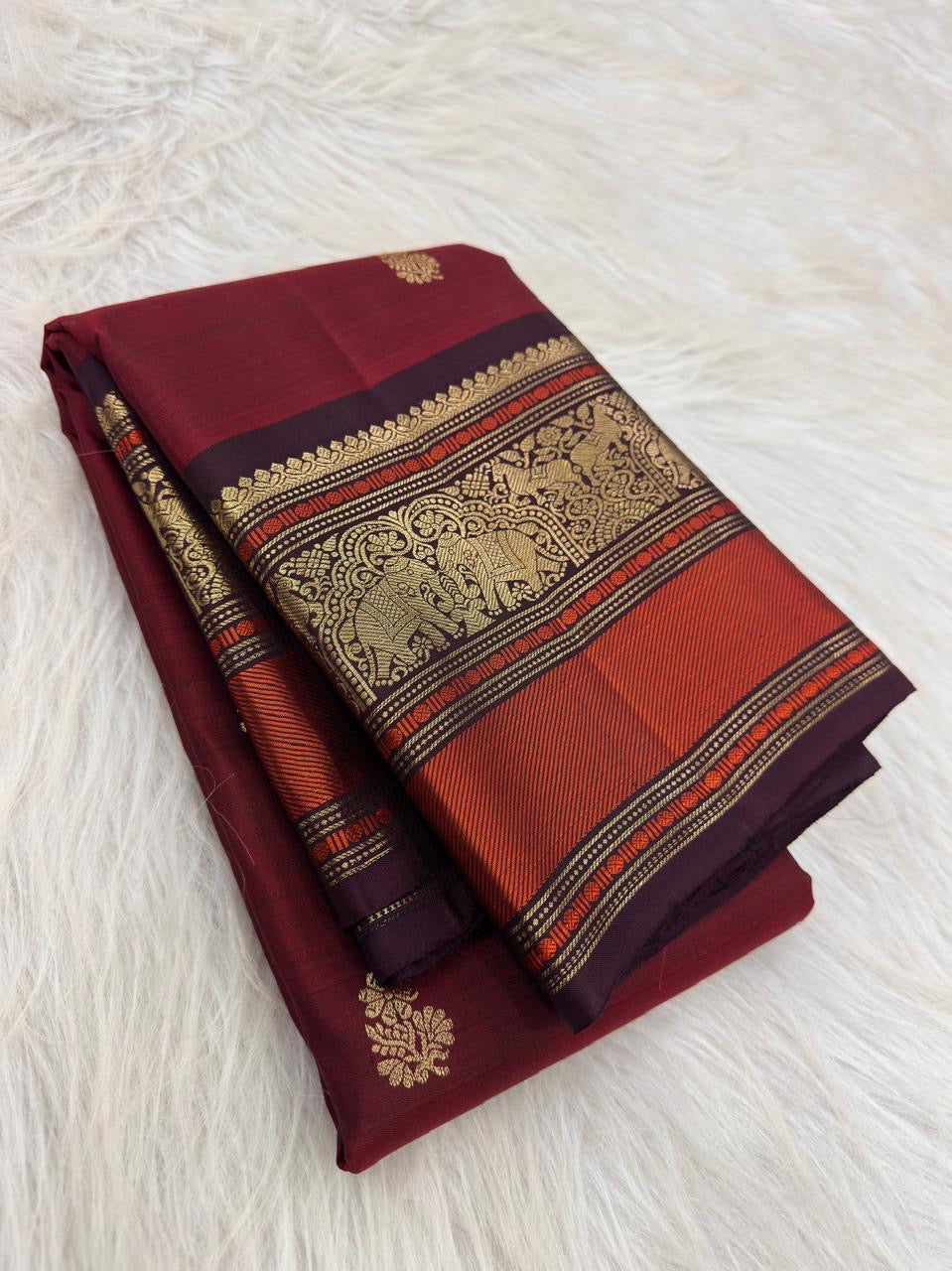 Arakku Red Kanchipuram silk saree with spaced floral gold zari buttas and purple orange Varisaipet border.