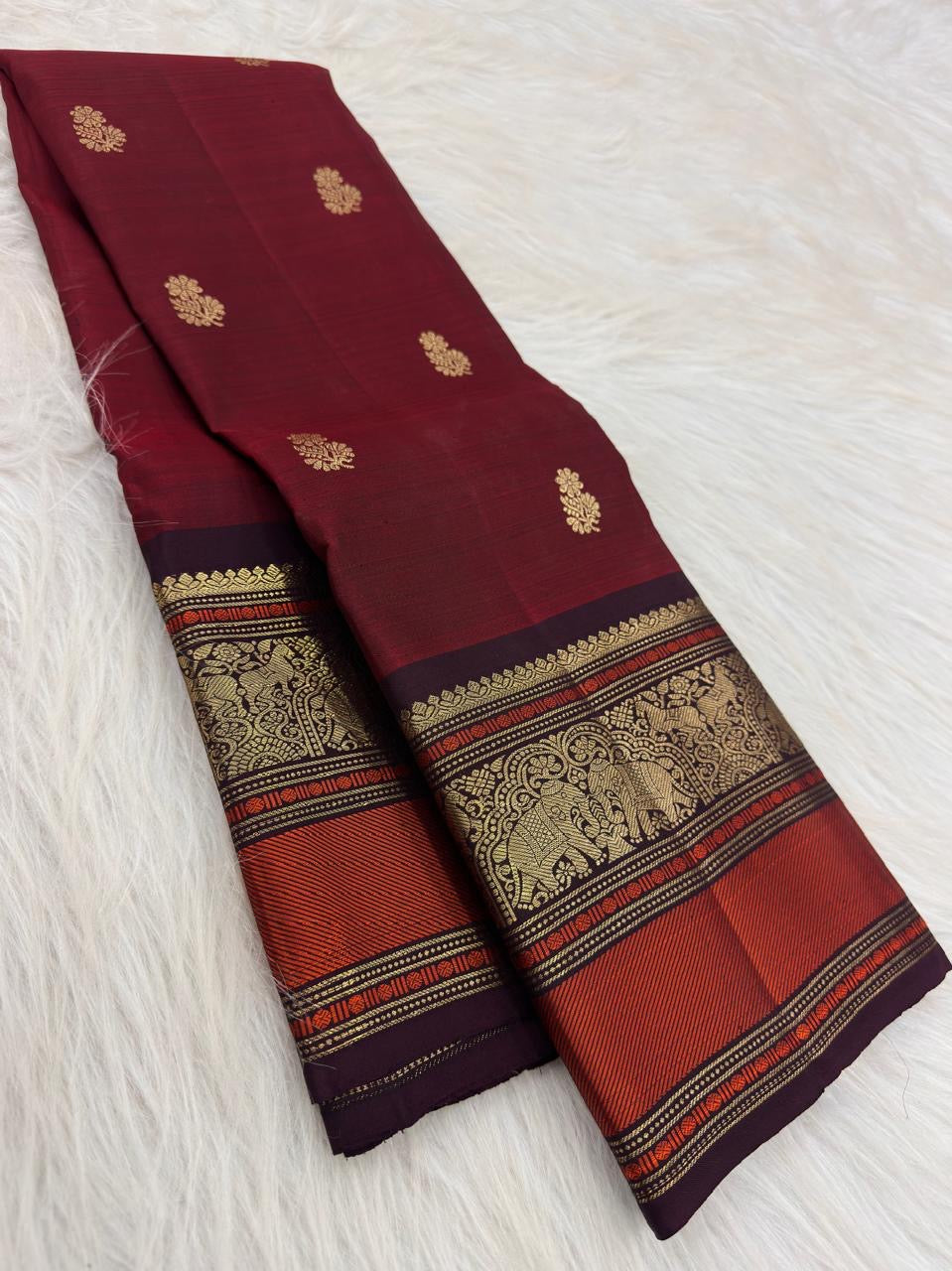 Arakku Red pure mulberry silk Kanchipuram saree with gold floral buttas and traditional elephant border.