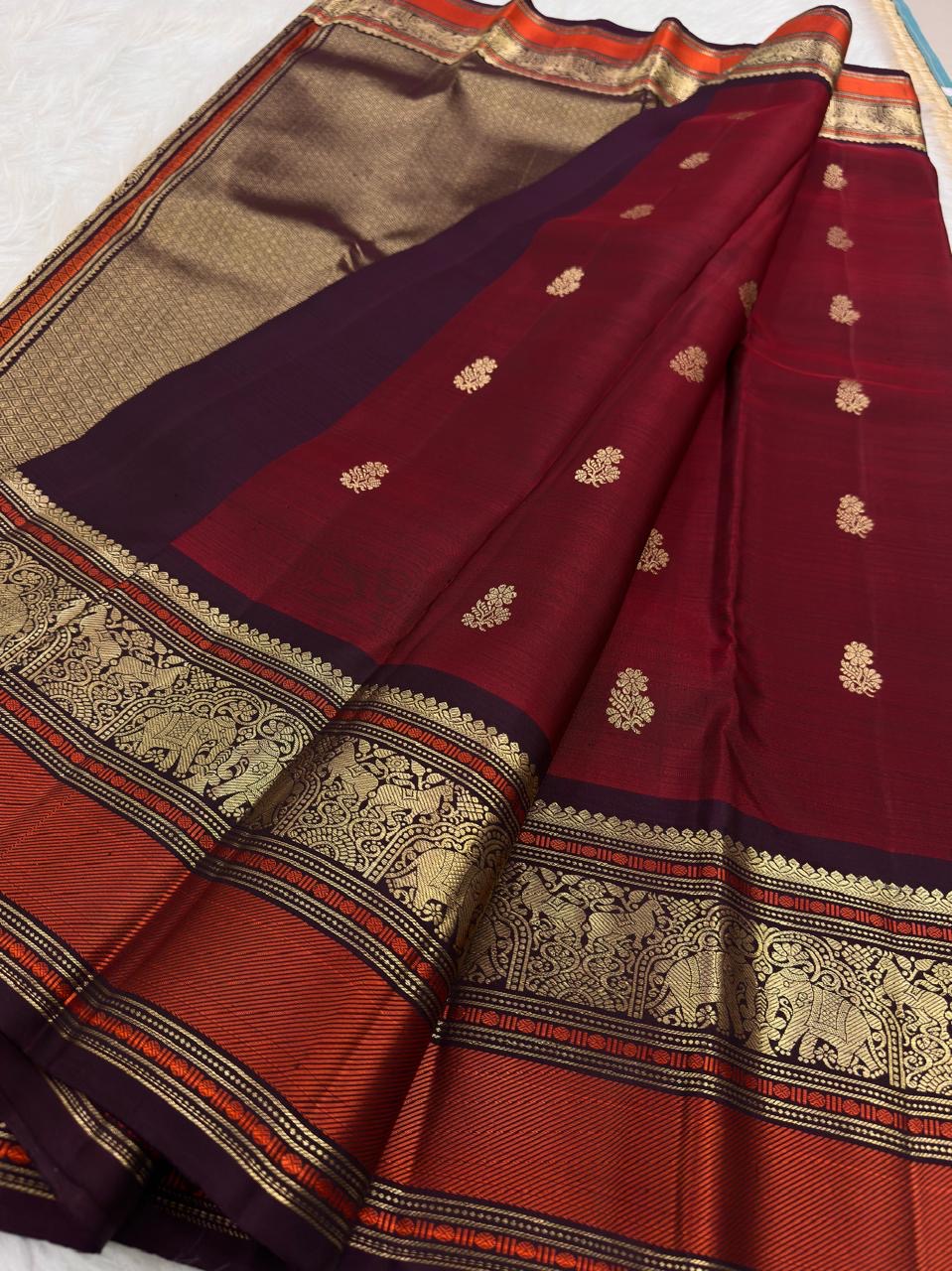 Deep Aubergine Varisaipet border with large Yaanai gold zari motifs on Arakku Red pure silk saree.