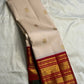 Close view of Arakku Red gold zari Korvai border on Sandalwood Ivory silk.