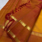 Gold zari band detail on Arakku red border, Manjal orange Kanjeevaram saree