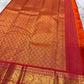 Tomato red pink shot colour Kancheepuram silk saree folded showing Vairaoosi body with Kamalam butta and ornate self-colour Mayil gold zari border