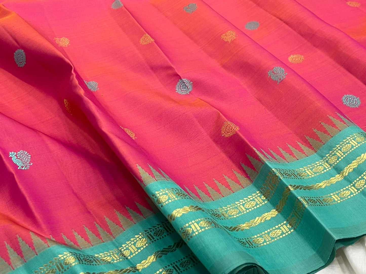 Teal pallu of shot colour tomato red pink Kancheepuram silk saree with antique gold zari Varisaipet cascade