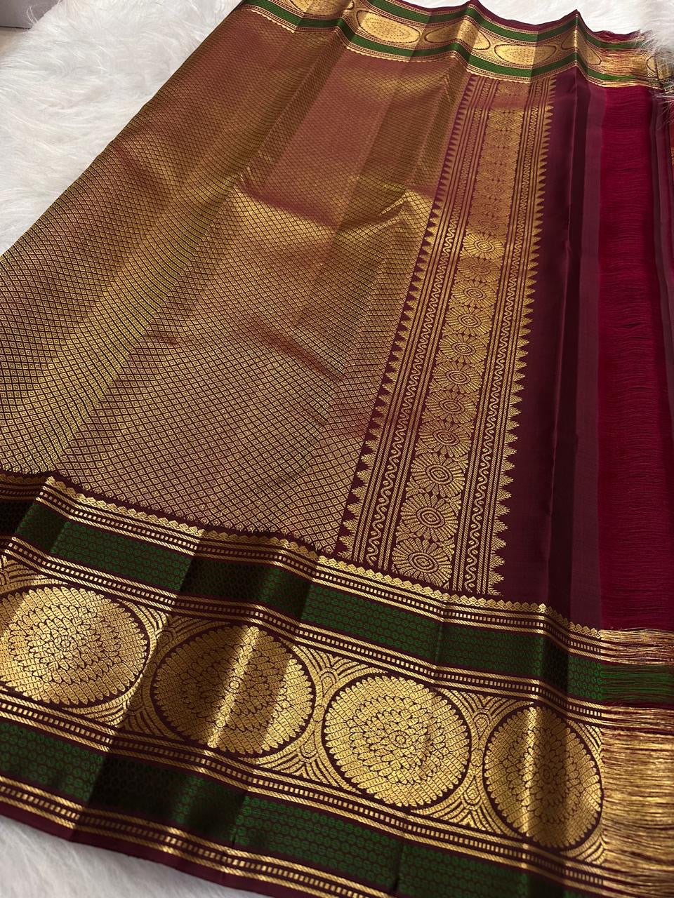 Handwoven red Kanjivaram saree with Deep Aubergine and Peacock Green contrast border
