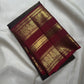 Deep Coffee Brown Pure Silk body with petite zari buttas and broad traditional peacock gold zari border.